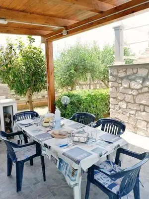 a white table and chairs on a patio at Villa Giulia in Alcamo Marina