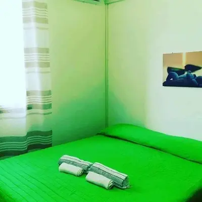 two towels on a green bed in a room at Villa Giulia in Alcamo Marina
