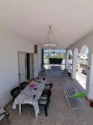 a living room with a wooden table and a piano at Villa Giulia in Alcamo Marina