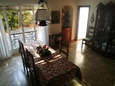 a dining room with a table with flowers on it at VILLA LEA in Mondello
