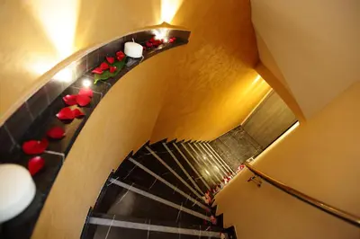 an overhead view of a spiral staircase with red roses at Vanity SPA in Balestrate