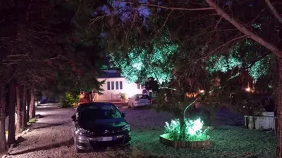 a car parked in the driveway of a house at night at Casa Vacanze Mari in San Vito lo Capo