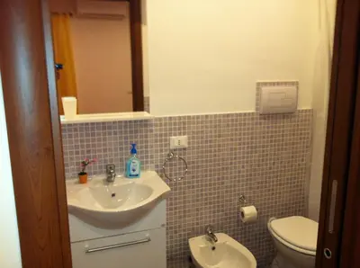 a bathroom with a sink and a toilet at Casa Vacanze Mari in San Vito lo Capo