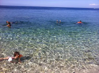 a group of people swimming in the water at Casa Vacanze Mari in San Vito lo Capo