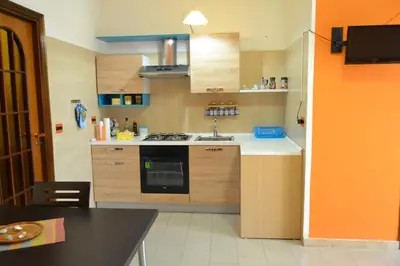 a kitchen with a sink and a stove top oven at Casa Vacanze Laura in Isola delle Femmine