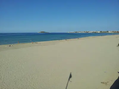 a beach with a lot of people in the water at Casa Vacanze Laura in Isola delle Femmine