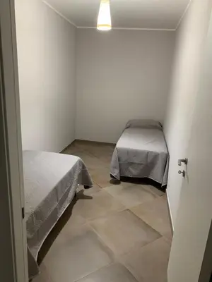 a bedroom with two beds and a tiled floor at DREAM CORLEONE in Corleone