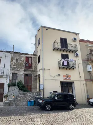 a black car parked in front of a building at DREAM CORLEONE in Corleone