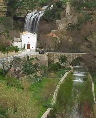 a painting of a waterfall and a stone bridge at DREAM CORLEONE in Corleone