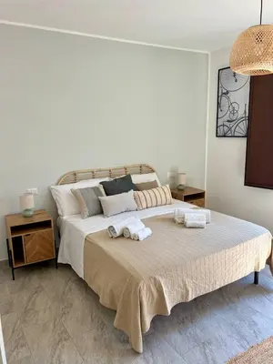 a bedroom with a large bed with towels on it at Casa Helios in Castellammare del Golfo