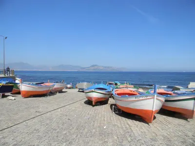 a group of boats lined up on the beach at Blue Island Villa Caterina in Casteldaccia
