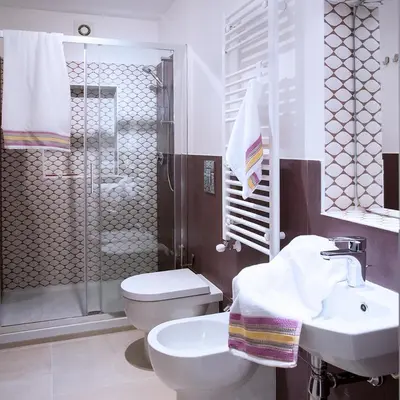 a bathroom with a toilet and a sink and a shower at SpasimoH-3 in Palermo