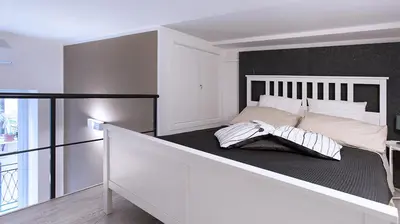 a bedroom with a large bed with a black wall at SpasimoH-3 in Palermo