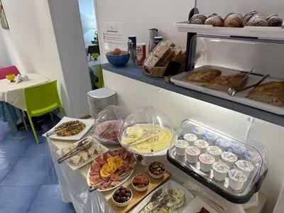 a buffet with various types of pastries and muffins at Badia Rooms & Breakfast in Castellammare del Golfo