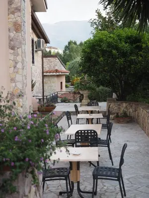 a row of tables and chairs in a courtyard at B&B Al Giardino in Monreale