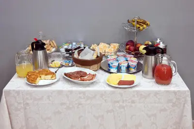 a table with breakfast foods and drinks on it at Operà in Palermo