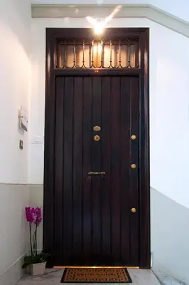 a wooden door with a light on top of it at Operà in Palermo