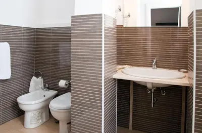 a bathroom with a toilet and a sink at Operà in Palermo