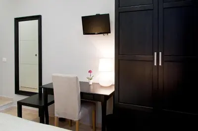 a bedroom with a desk and a chair and a cabinet at Operà in Palermo