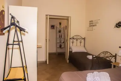 a room with a bedroom with a bed and a ladder at Casa Primavera in Palermo
