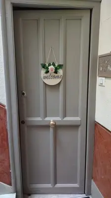 a gray door with a flower pot on it at Casa Primavera in Palermo