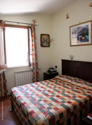 a bedroom with a bed with a checkered blanket at Donna Lia in Bagheria