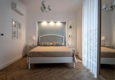 a bedroom with a bed in a white room at Casa Novelli Apartments in Monreale