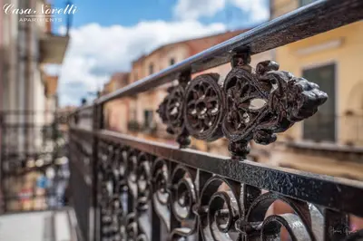 a close up of a black wrought iron fence at Casa Novelli Apartments in Monreale