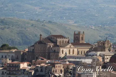 a group of buildings in front of a mountain at Casa Novelli Apartments in Monreale