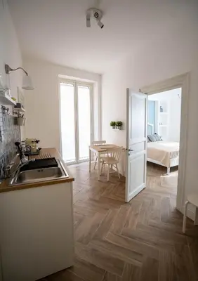 a kitchen with a sink and a refrigerator in a room at Casa Novelli Apartments in Monreale