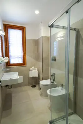 a bathroom with a toilet and a sink and a shower at Residence Marinella in San Vito lo Capo