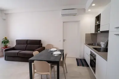 a living room with a table and a couch at Residence Marinella in San Vito lo Capo
