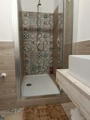 a bathroom with a shower and a sink at Sicily Rooms Appartamenti in Carini