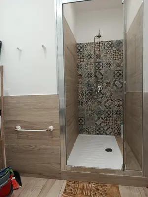 a shower with a glass door in a bathroom at Sicily Rooms Appartamenti in Carini