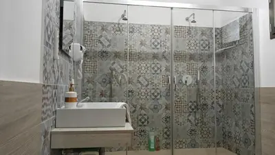 a bathroom with a sink and a shower at Sicily Rooms Appartamenti in Carini