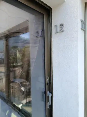 a glass door of a building with the number at Sicily Rooms Appartamenti in Carini