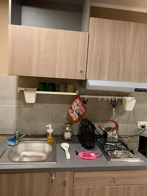 a kitchen counter with a sink and a stove at Casa Rosina in Palermo