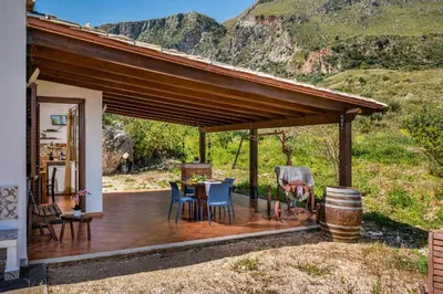 a wooden deck with a table and chairs on a house at Villa Elena vicino la Riserva naturale dello Zingaro in Scopello