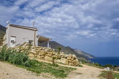 a house on top of a pile of rocks at Villa Rosaria vicino la Riserva dello Zingaro in Scopello