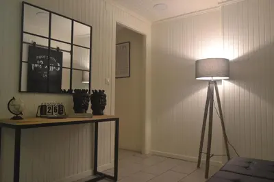a room with a lamp and a table with a mirror at Casa in centro in Palermo