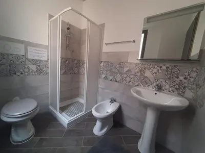 a bathroom with a shower and a toilet and a sink at Affitta Camere Al Castello in Palermo