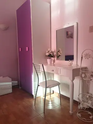 a bathroom with a sink and a chair and a mirror at Affitta Camere Al Castello in Palermo