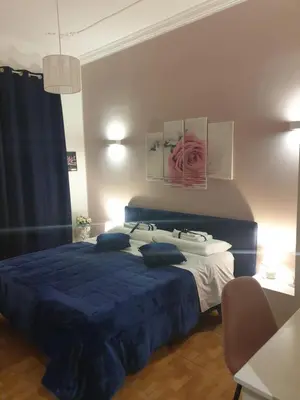 a bedroom with a blue bed with a blue bedspread at Affitta Camere Al Castello in Palermo