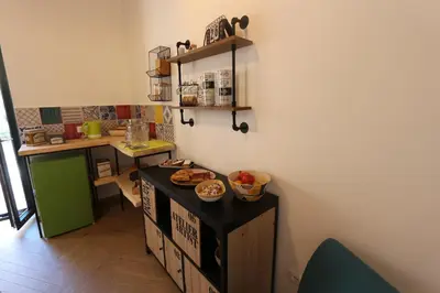 a kitchen with a counter with some food on it at Torre's Camere & caffè in Monreale