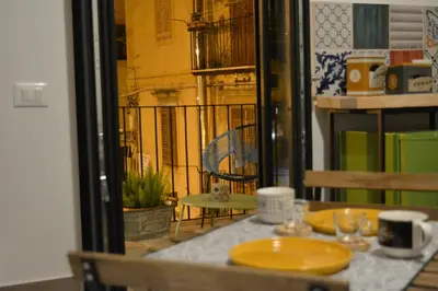 a table with a yellow plate on top of it at Torre's Camere & caffè in Monreale