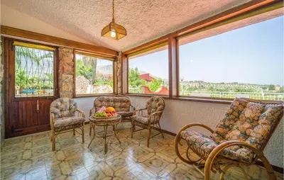 a room with a table and chairs and windows at Awesome Home In Trabia With Wifi in Trabia