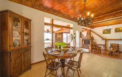 a dining room with a table and chairs and a chandelier at Awesome Home In Trabia With Wifi in Trabia