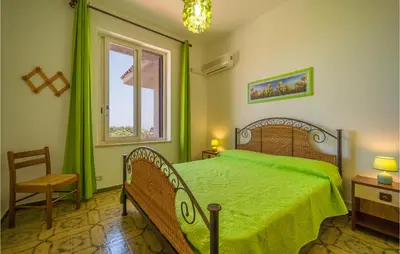 a bedroom with a green bed and a window at Awesome Home In Trabia With Wifi in Trabia