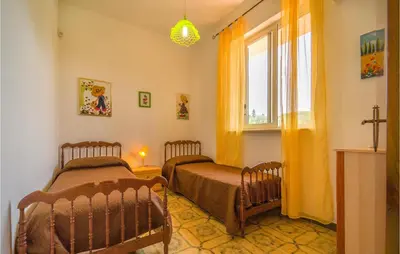 two twin beds in a room with a window at Awesome Home In Trabia With Wifi in Trabia