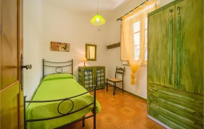 a bedroom with a green bed and a window at Awesome Home In Trabia With Wifi in Trabia